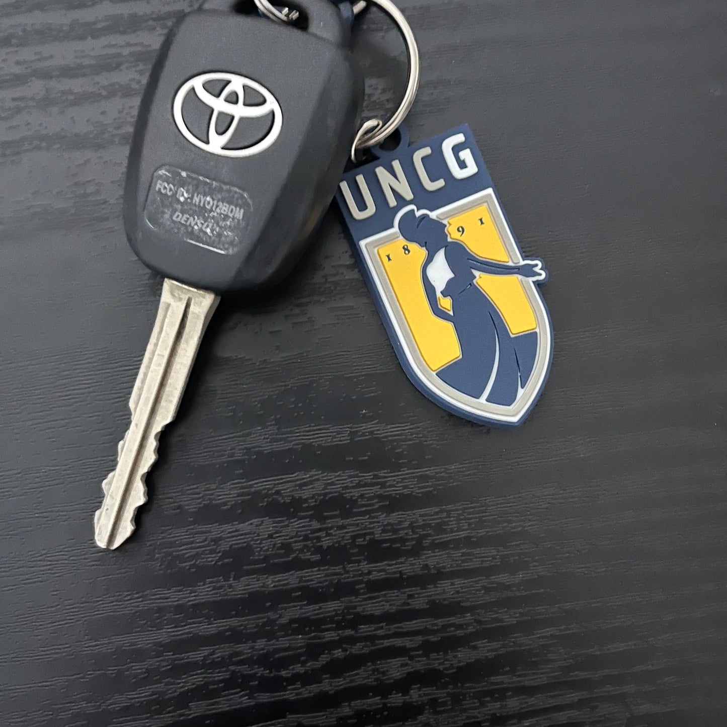 Key Chain - UNCG Emblem logo in PVC material, poly-bagged.